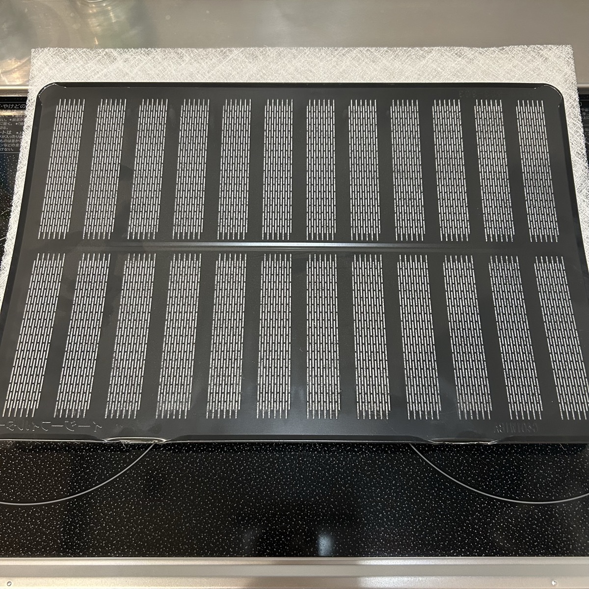 取り外したレンジフードのカバーとスターフィルターのシート